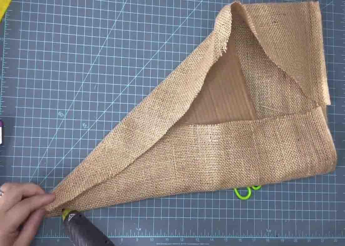 Wrapping the cardboard with burlap for the gnome wreath