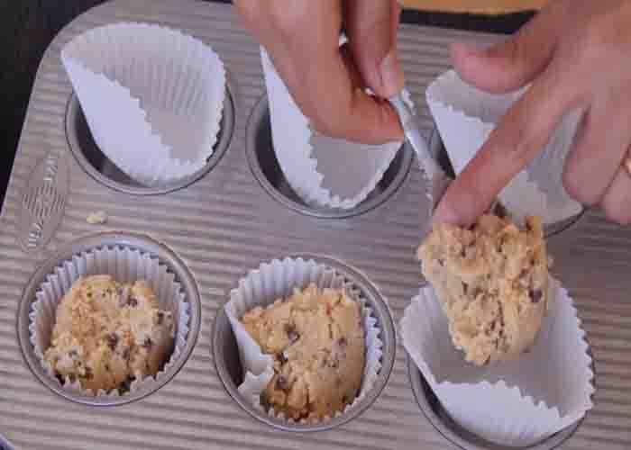 Dividing the cookie dough on each cupcake liner