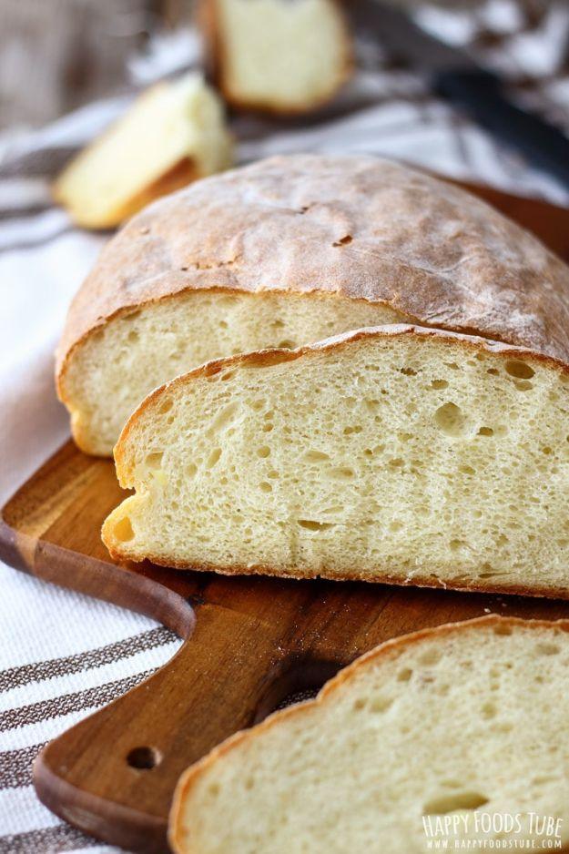 Homemade potato bread loaf with a soft pale crust, sliced to show a fine and tender crumb on a wooden board