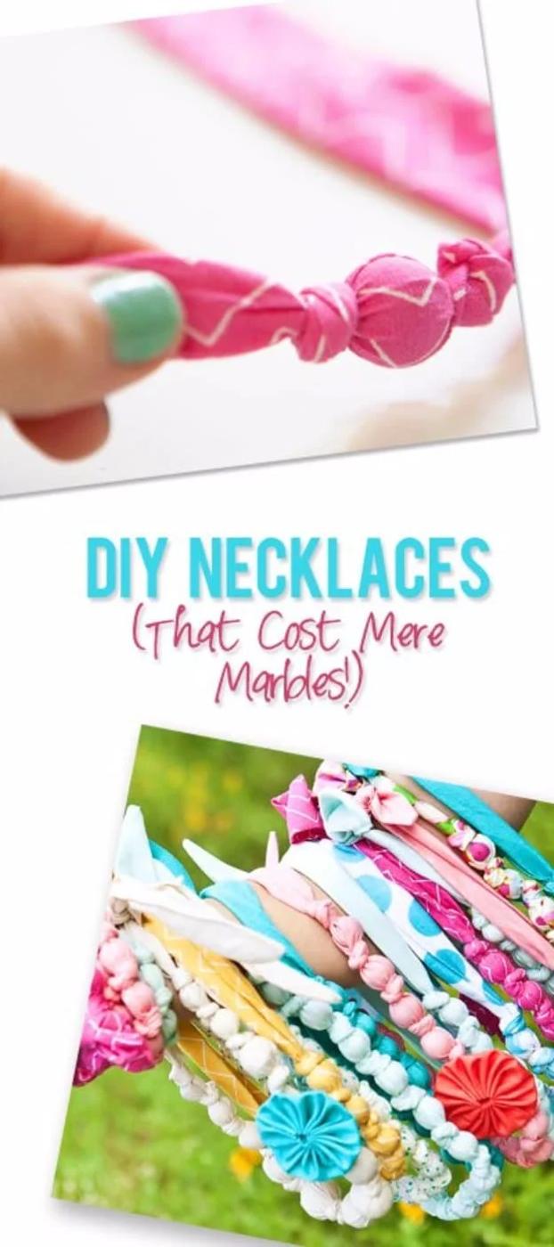 Stacked knotted fabric necklaces in pink, turquoise and yellow prints with marbles inside, shown close up and worn on an arm