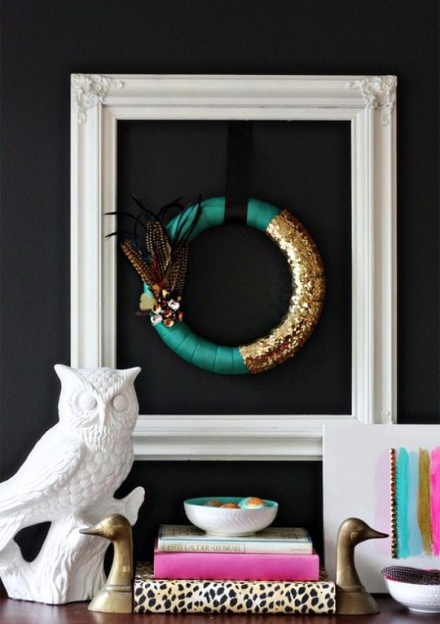 Emerald green feather wreath with the feathers layered tips outward, a bold fall wreath for a front door