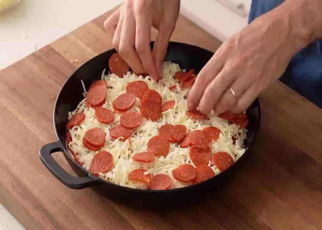 Putting the pizza toppings over the top