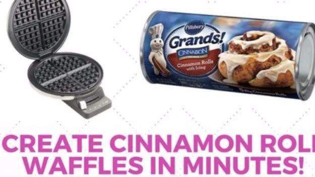 Open waffle iron beside a tube of refrigerated cinnamon rolls on a pink and white graphic background