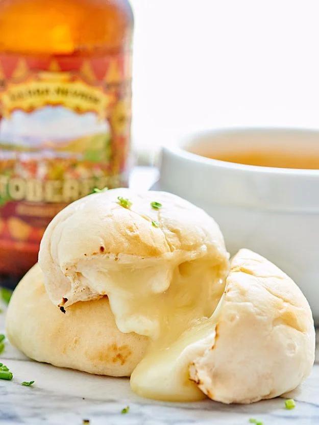 Golden cheese bombs made from canned biscuits stuffed with molten mozzarella and brushed with garlic butter