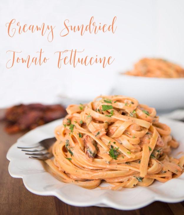 Creamy sundried tomato fettuccine copycat with baby spinach, parmesan and julienned sun dried tomatoes