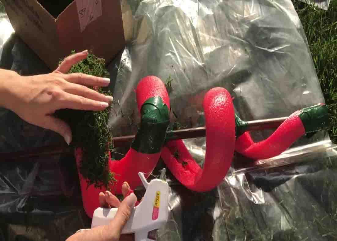 Gluing the moss all over the DIY spiral topiary
