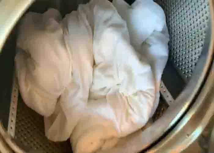Wringing the excess water from the white clothes