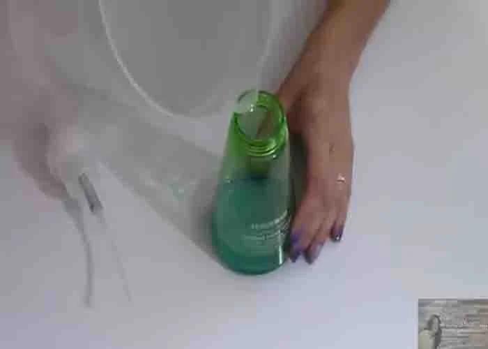 Adding water to the pump bottle with Dawn dish soap