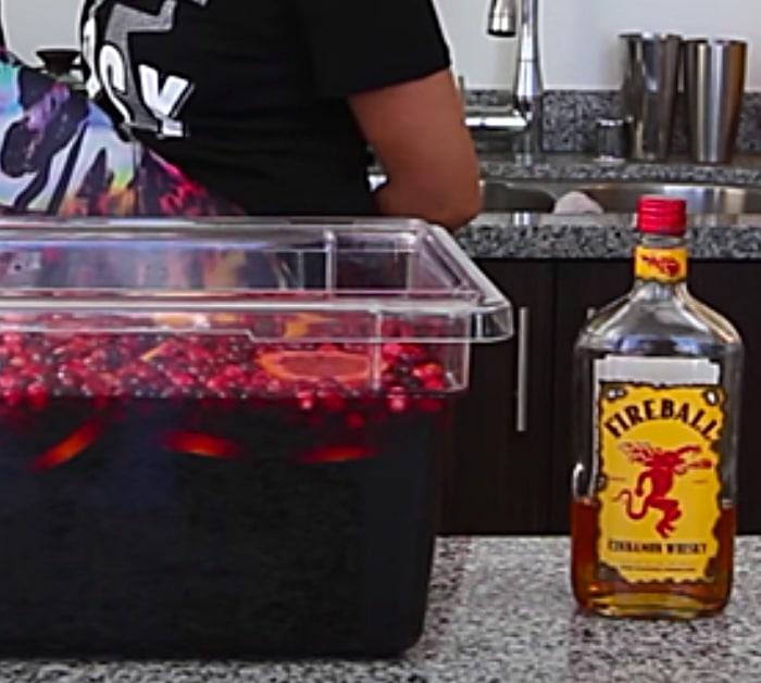Try a boozy Merlot, vodka, and Fireball Devil's Jungle juice Party Punch For Christmas guests