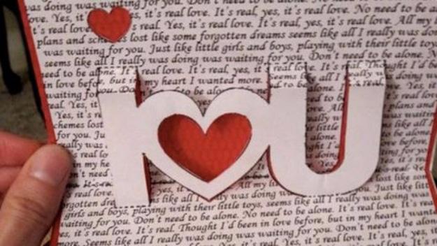 DIY pop up Valentine's Day card cut from printed paper with a hidden message opening out of the fold