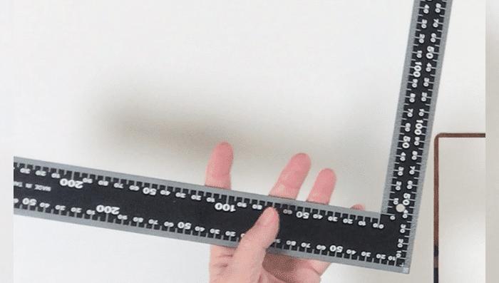 Ruling used to measure sewing project for handmade coffee cozy made from scrap fabric pieces