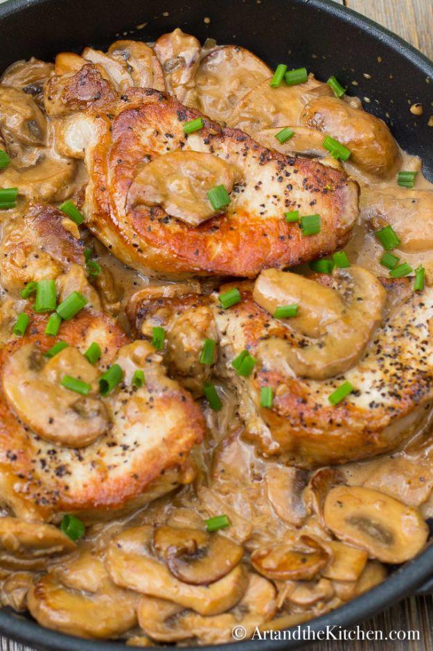 Pork chops with brandy mushroom sauce, thick sliced mushrooms and shallots in a cream sauce topped with chives