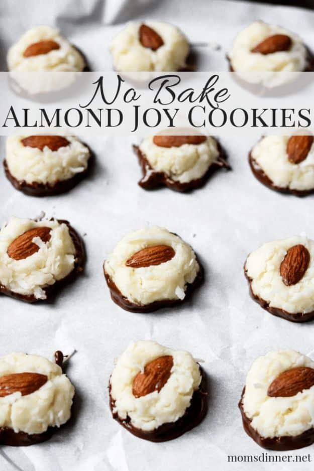 No bake almond joy cookies, white coconut mounds each topped with a whole almond and dipped in chocolate