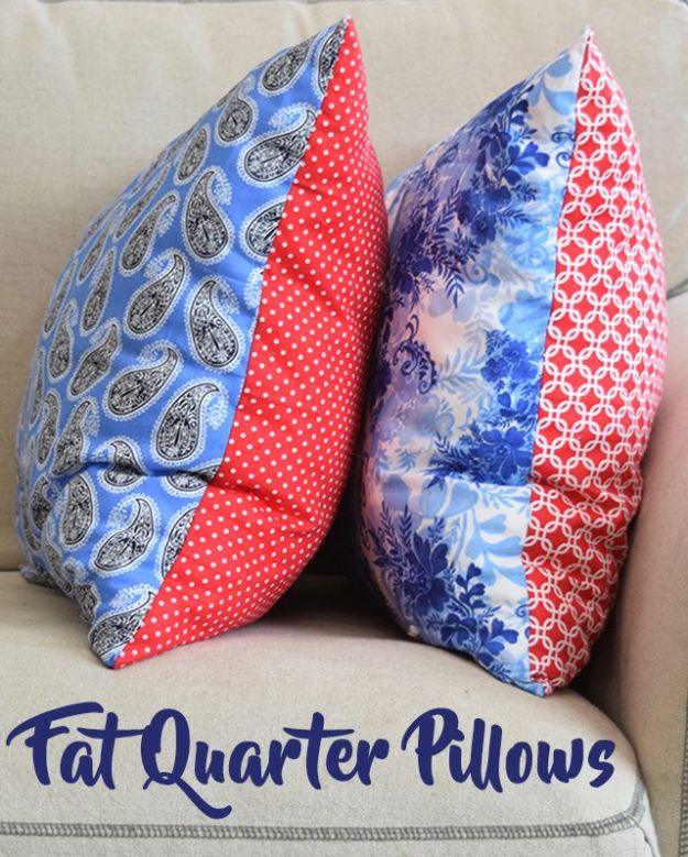 Two fat quarter pillows, blue paisley and blue floral each paired with red, standing on a cream armchair