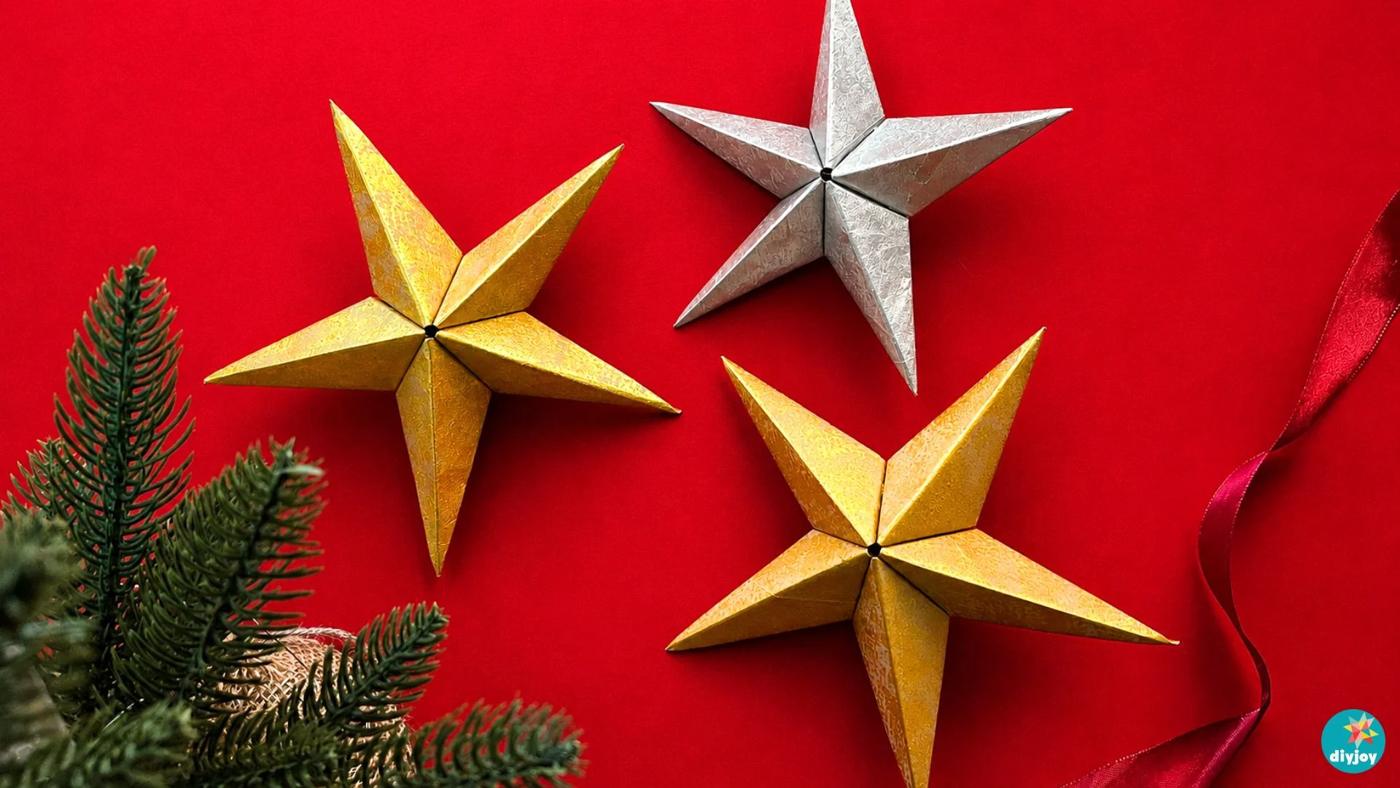 DIY paper bag star ornament - a finished 3D gold and silver Christmas star folded from painted kraft paper