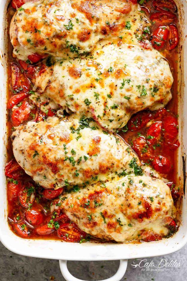 Balsamic baked chicken breast surrounded by blistered grape tomatoes and red onion under melted mozzarella