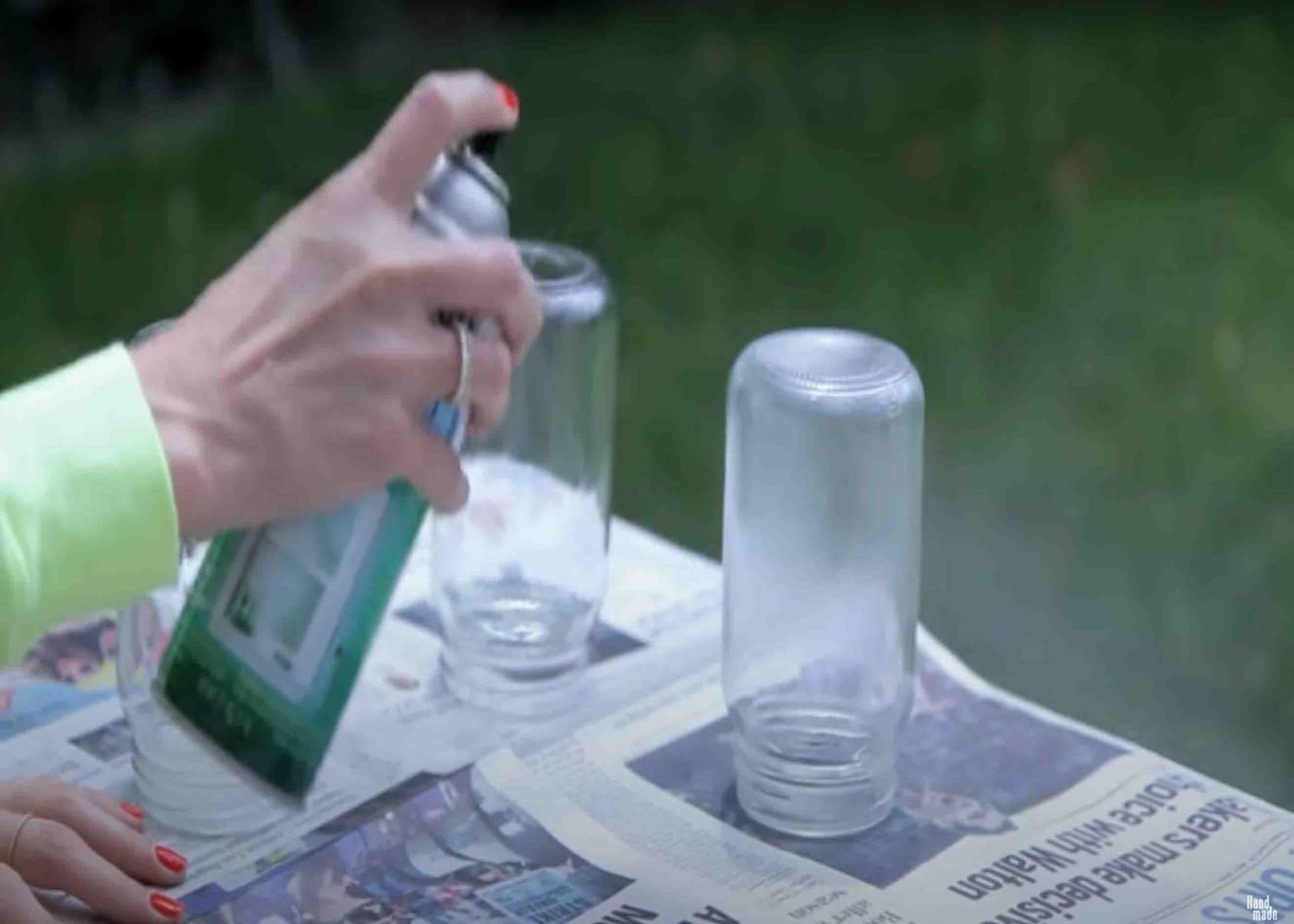Spraying some frosted glass spray into the mason jars