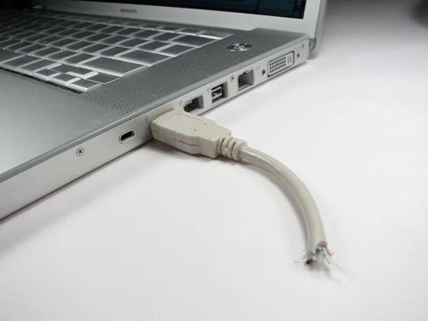 Laptop with a short frayed USB cable stub plugged into the port, which is actually a disguised flash drive