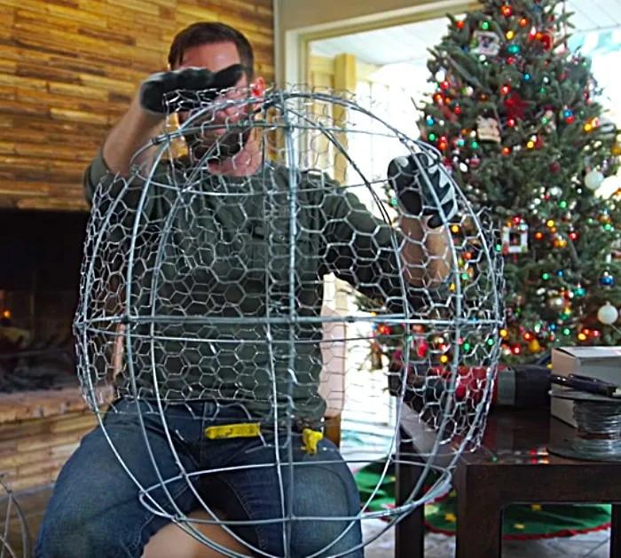 Try this cheap chicken wire and fairy light giant Christmas Ball For your outdoor decor