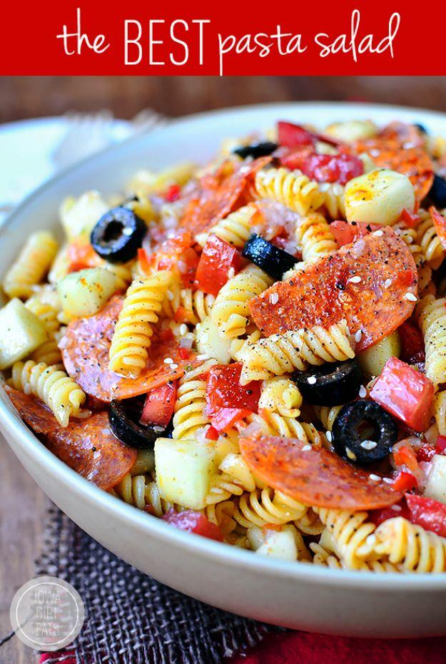 Typeset pin graphic of a white bowl of rotini pasta salad with pepperoni, black olives, cucumber and red pepper