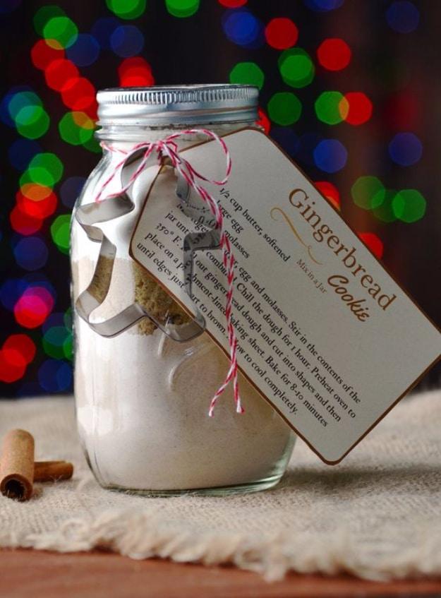 Quart jar of gingerbread cookie mix with a printed instruction tag and a metal cookie cutter tied on top
