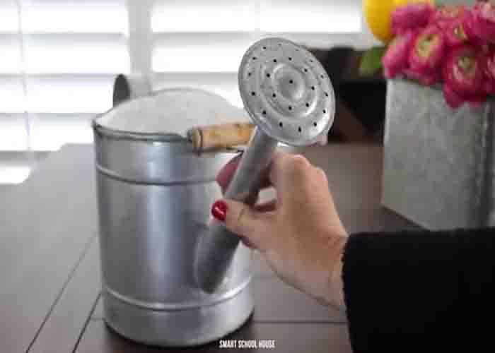 Removing the showerhead of the watering can