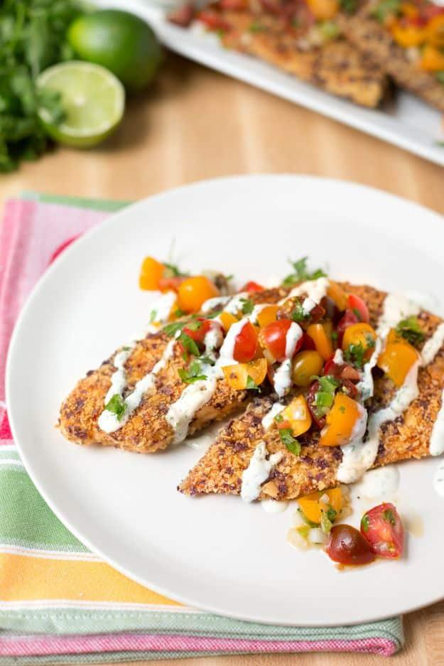 Tortilla crusted tilapia topped with cherry tomato pico de gallo and cilantro lime crema, an easy fish dinner