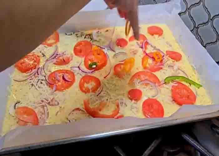 Assembling the pizza sheet pan casserole