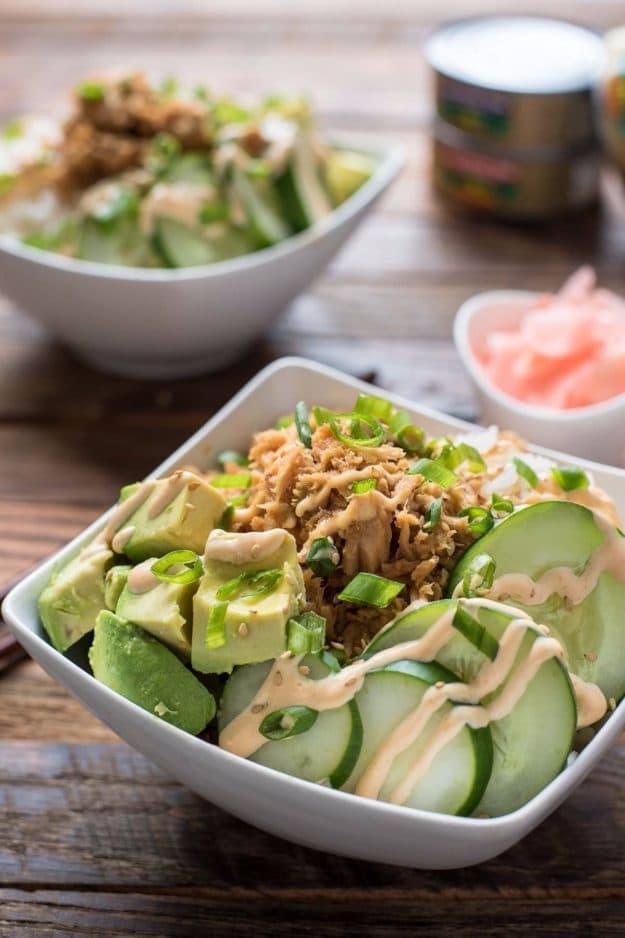 Spicy tuna sushi bowl with rice, sliced avocado, cucumber, pickled ginger and a drizzle of spicy mayo