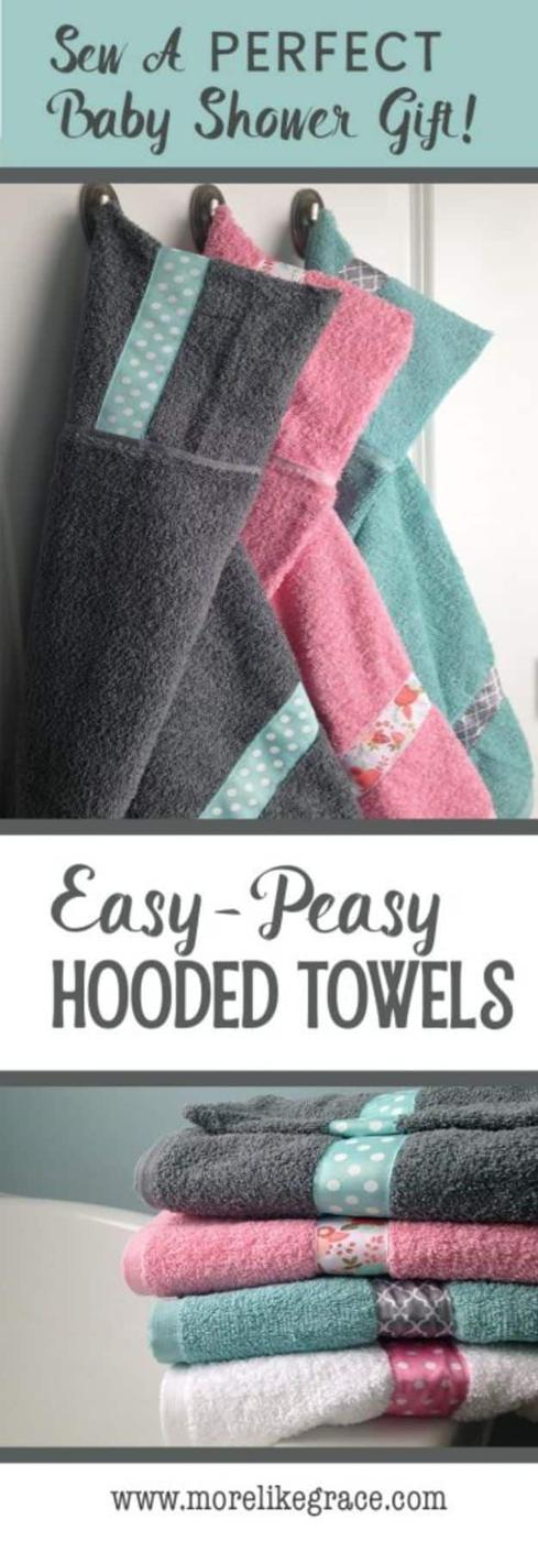 Easy peasy hooded towels in grey, pink and teal trimmed with ribbon, hanging on hooks above a folded stack of towels