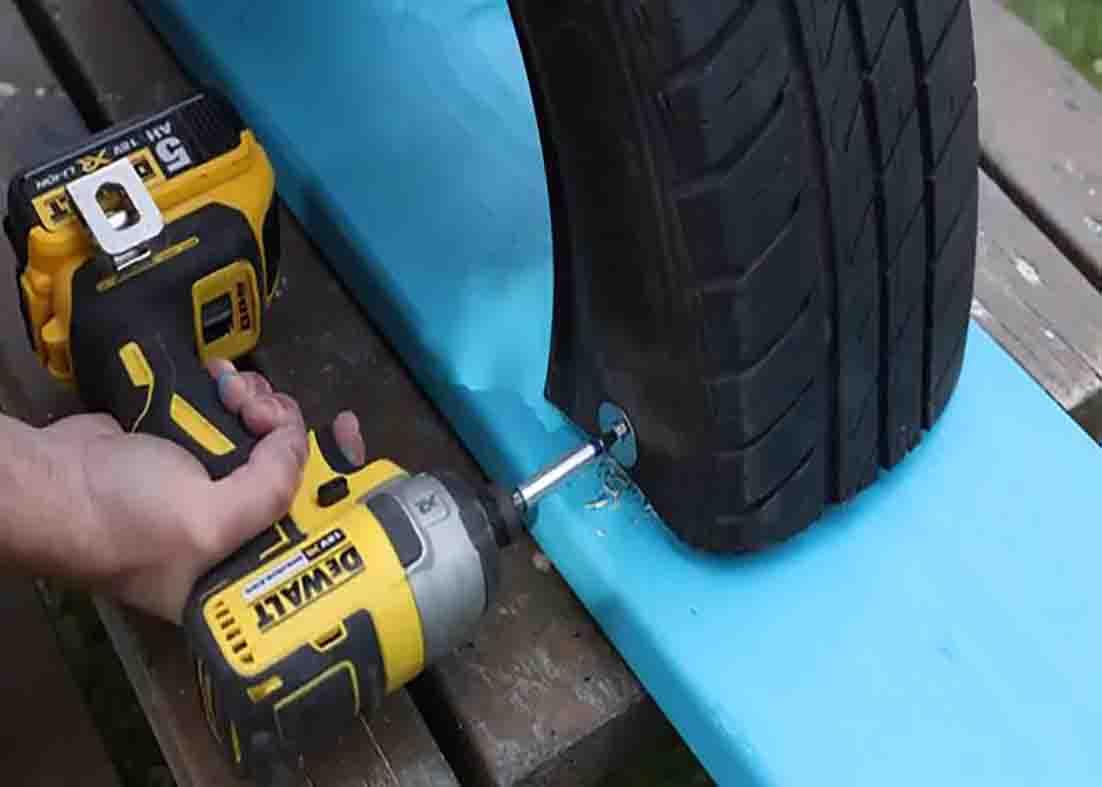Screwing the tire on the board to secure it
