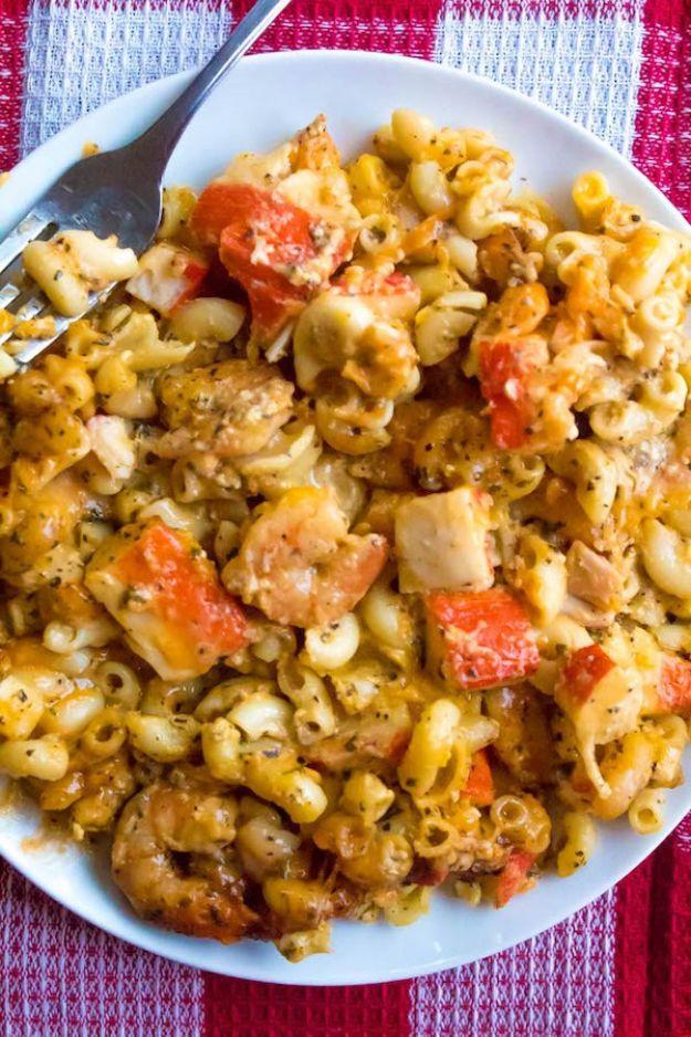 Cajun shrimp and crab mac and cheese in a white bowl, pink shrimp and crab tucked through elbow pasta