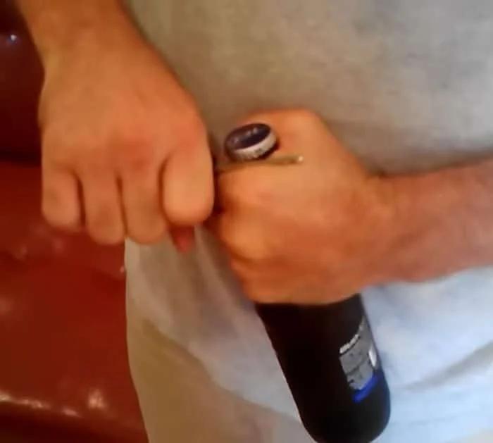 Car key beer bottle hack, the slender metal part of a key slid under the cap edge and twisted up to pop it