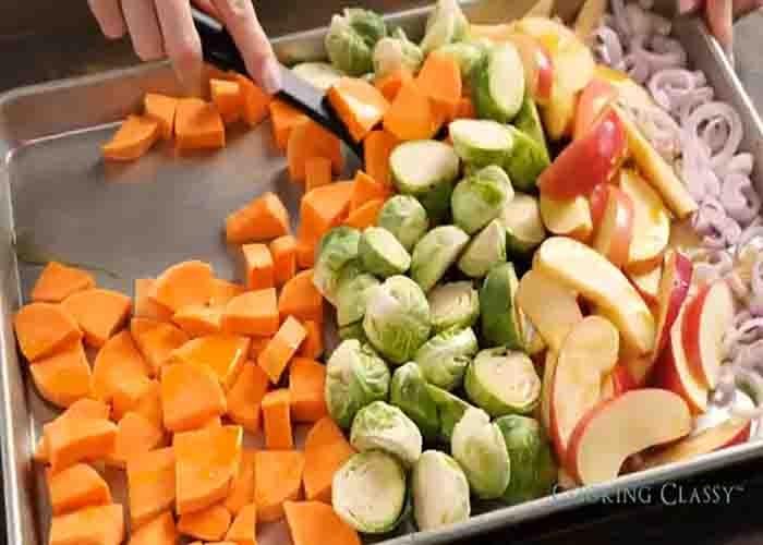 Seasoning the veggies for the one-pan chicken dinner recipe