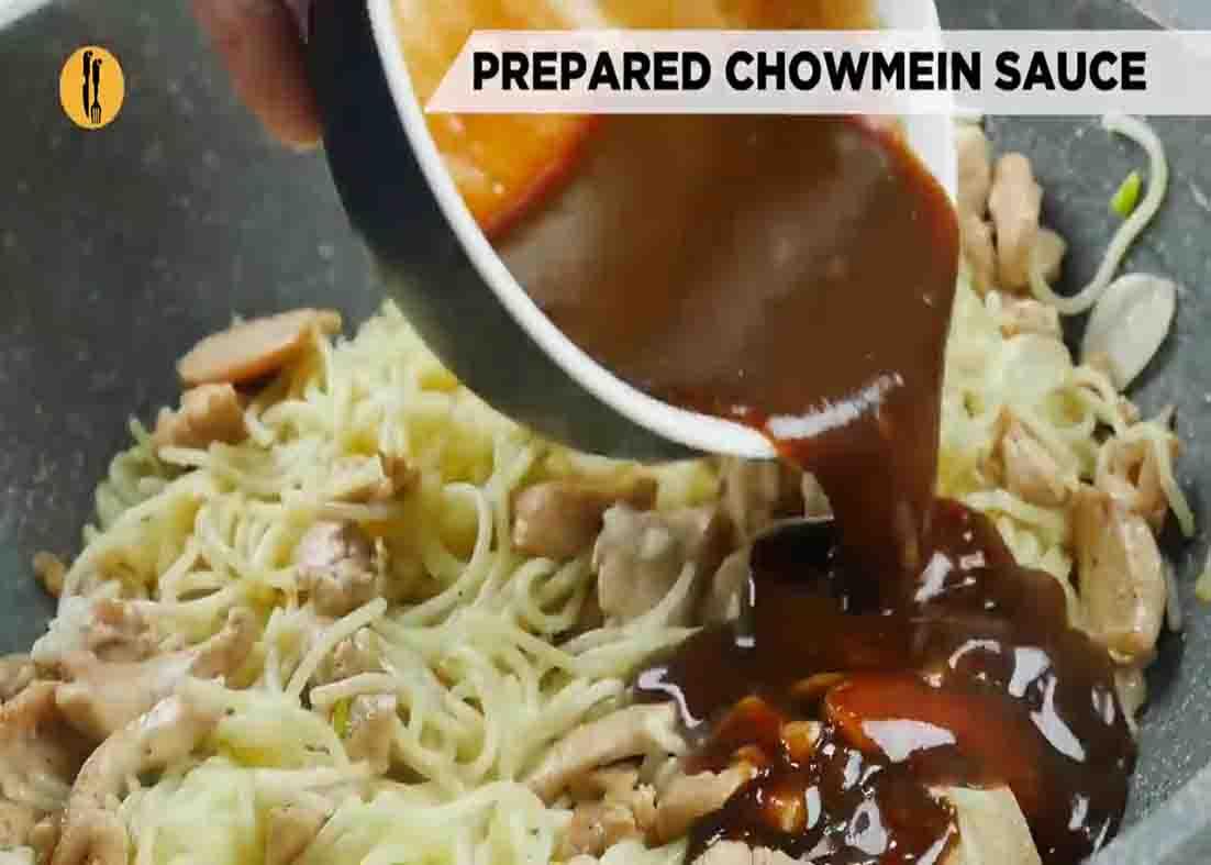 Adding the chicken chow mein sauce to the noodles