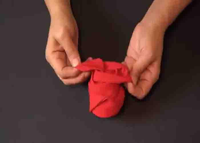 Folding a cloth napkin into a rose