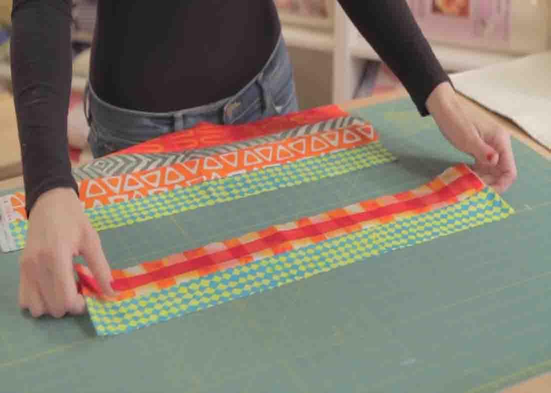 Sewing the strips together to make the coin quilt strip set