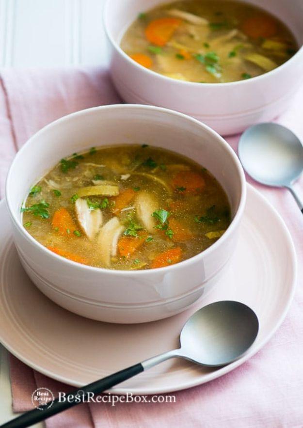 Slow cooker chicken vegetable soup in two white bowls with shredded chicken, carrot slices and parsley