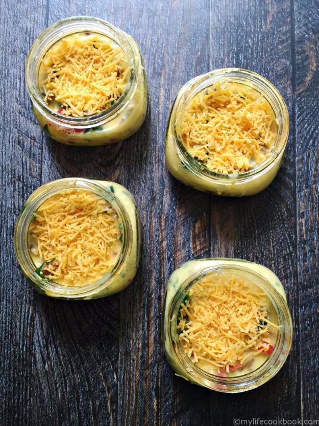 Sausage spinach and pepper omelette baked in a jar with cheddar, peppers and spinach set through the eggs