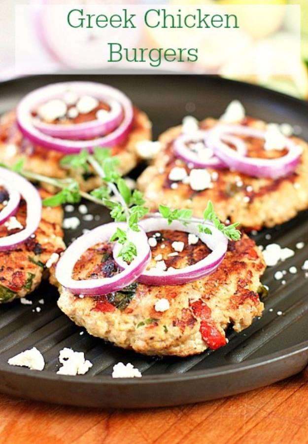Greek chicken burgers made with feta, spinach and oregano, grilled and served bunless with salad at a backyard cookout