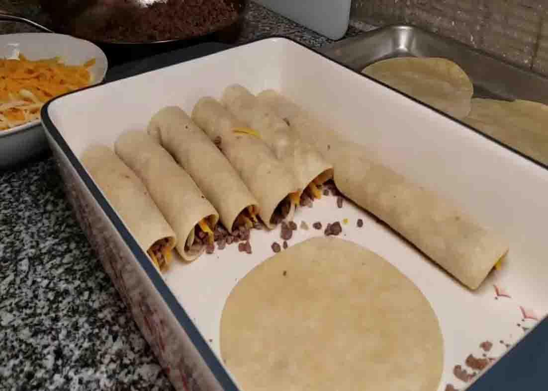 Arranging the enchiladas in the casserole dish