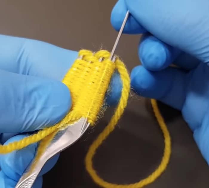 Make a yarn flower out of yarn and a fork