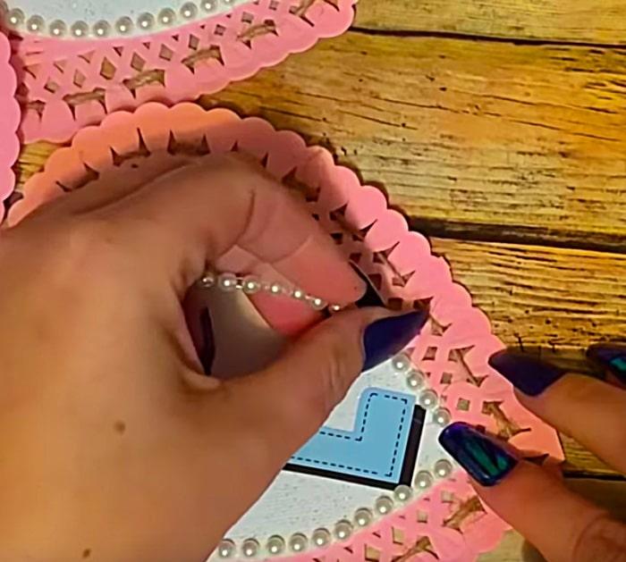 Learn to make a DIY Paper Doily Heart Banner with materials from Dollar Tree