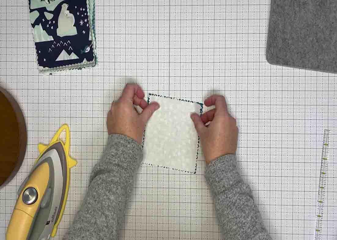Stacking the printed and the solid-colored fabric to make the triangles