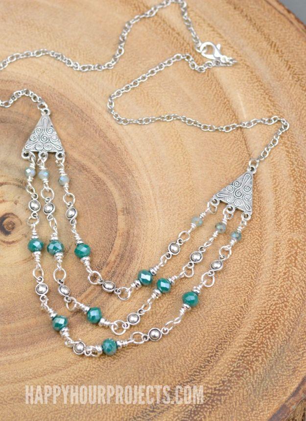 Triple strand crystal and pewter necklace, three silver beaded strands with teal beads on a round wooden slice