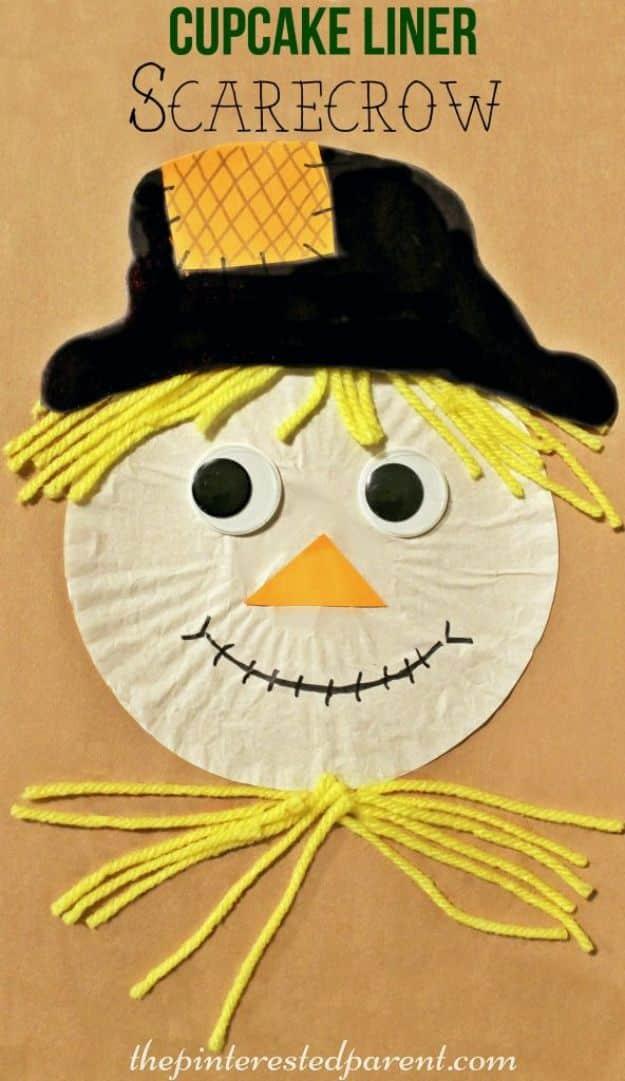 Pin graphic reading Cupcake Liner Scarecrow, a scarecrow face made from a white cupcake liner with yellow yarn hair