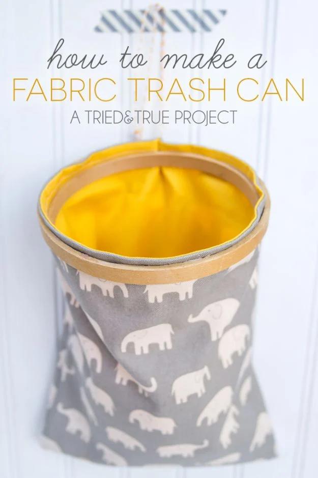 Gray elephant print fabric trash can with a yellow lining held open by a wooden embroidery hoop, under a typeset title