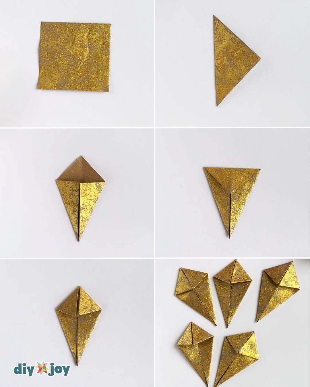 Folded paper star craft - diagonal folds turning a painted square into a kite shaped point, step two