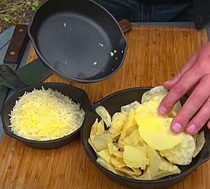 Potato chips and cheese on a bacon and egg pie