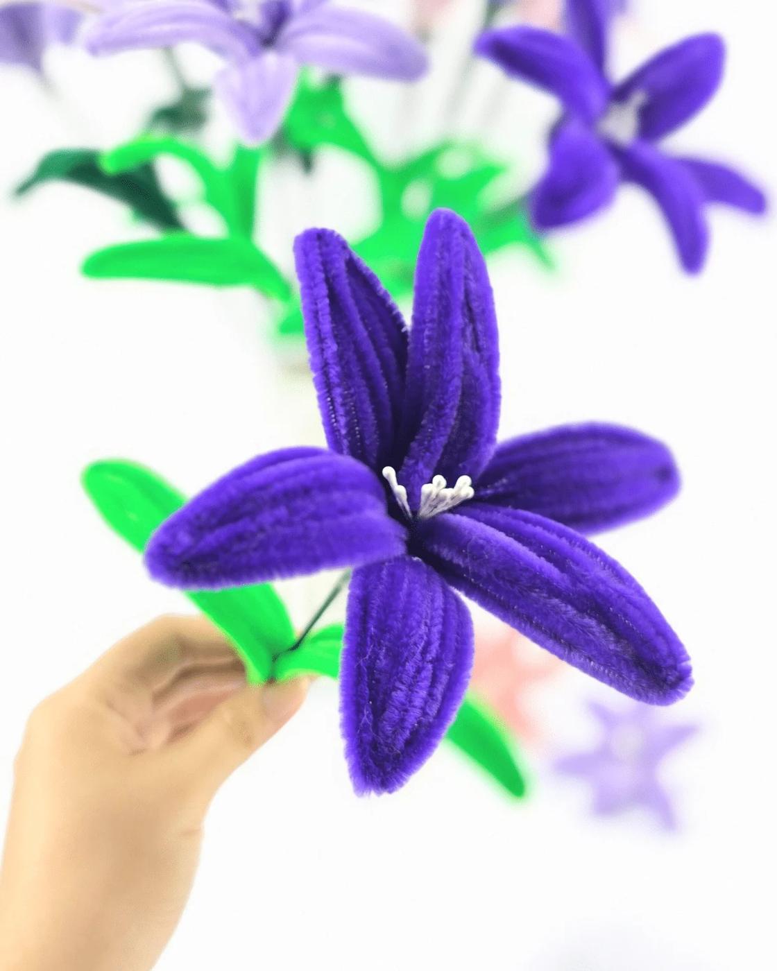 Handmade pipe cleaner lilies arranged together, an easy chenille stem craft that never wilts or needs water